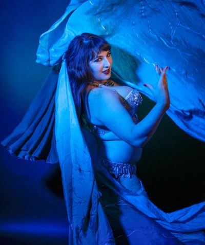 Athena plays with silk veils while washed in blue light